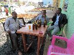 Group relaxes with a beear, Inda Aba Guna, Ethiopia