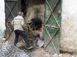 Stoking the furnace of the hammam, Sefrou, Morocco