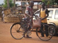 Vogan, Togo, bicyclist bring goods to the market
