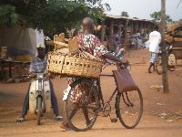 Vogan, Togo, bicyclist bring goods to the market