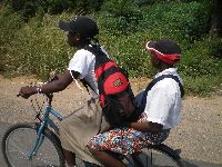 Lome, Togo, students bicycling along coastal highway