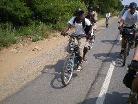 Lome, Togo, students bicycling along coastal highway