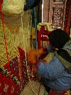 Woman weaving knoted wool rug, Kairouan