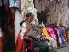 Otavalo market, sales person reading between customers