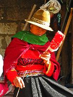 Ecuador, Salasaca: Woman spinning wool yarn