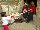 Ecuador, Salasaca: Women twisting yarn skein