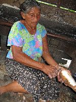 Peeling bitter casava in preparation for making casava bread