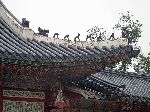 Figures guard the building. Gyeongbokgung