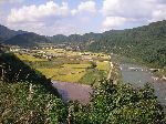 Agricultural valley and forested hillsides.