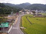 a sign of a low traffic road is rice drying on the road
