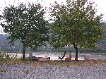 Old furniture under the trees by the river