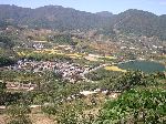 Farms on the valley floor and forest on the hillside