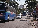 caravan of a dozen tour buses