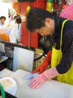 Preparing raw fish for the table, Sindonga Fish Market