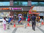 Joseon period royal guard marching in front of the Dunkin Donut shop, Seoul.