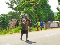 Sierra Leone, Kissi Town, man carrying out board motor