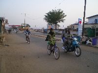 Sokode, Togo, bicyclist and motorcycle
