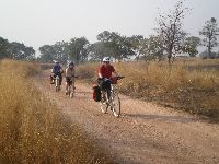 Bicycling into Tembera, Koutammakou World Heritage, Togo