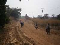 Bicycling into Tembera, Koutammakou World Heritage, Togo