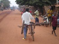 Vogan, Togo, bicyclist bring goods to the market