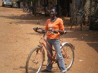 Togoville, Togo, street scene with girl bicyclist