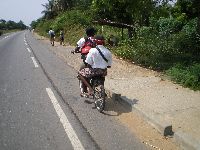 Lome, Togo, students bicycling along coastal highway