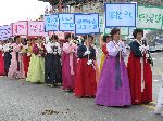 Women with placard of municipal accomplishments