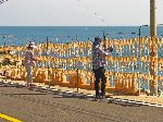 women hanging squid on lines to dry, Korea